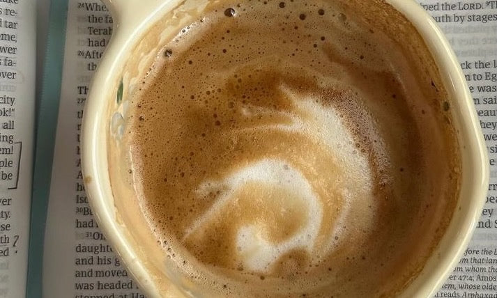 A freshly brewed macchiato, with a swirling dollop of frothy milk