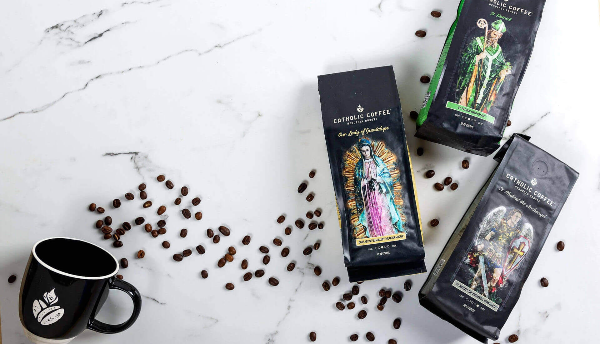 Catholic Coffee bags with a mug and coffee beans on a marble surface